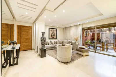 a living room with a couch and a table at Luxury 2-Bedroom Apartment in City Center Jacuzzi & Heated Pool in Marrakech