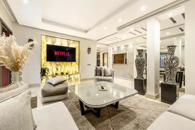 a living room with a table and chairs at Luxury 2-Bedroom Apartment in City Center Jacuzzi & Heated Pool in Marrakech