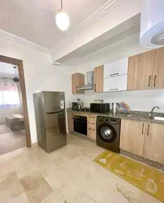 a kitchen with a stainless steel refrigerator and a dishwasher at Appartement de luxe à Marrakech in Marrakech