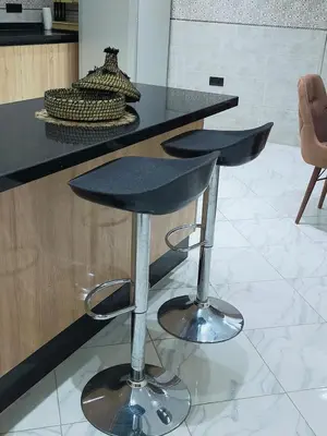 a black counter with a bar stool in a kitchen at Villa fahloui in Marrakech