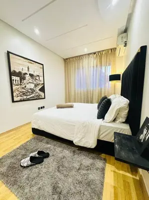 a bedroom with a large bed and a rug at Cosy House Marrakech Semlalia - Gueliz Center in Marrakech