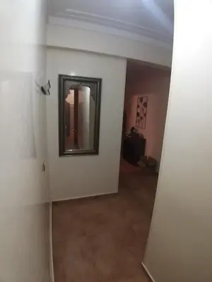 a hallway with a mirror on the wall in a room at Sweet home in Marrakech
