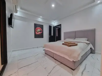 a bedroom with a large bed and a tiled floor at Kech vacations FRIENDLY! 2 bedroom luxury apartment in Marrakech