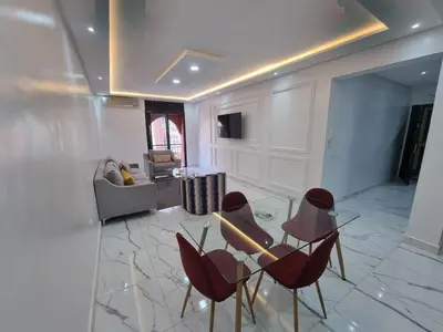 a living room with chairs and a glass table at Kech vacations FRIENDLY! 2 bedroom luxury apartment in Marrakech