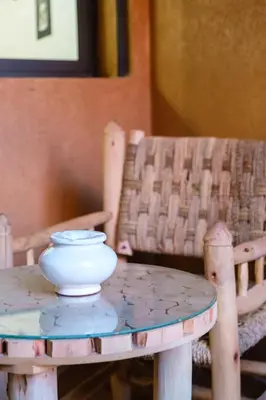 a white bowl sitting on a table next to two chairs at Confortable & Très Bien Noté - Vue Piscine, Proche M Avenue, Piscine, Fibre Optique, Parking in Marrakech