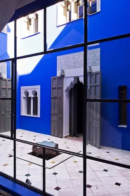 a view of a blue building through a window at Riad Goloboy in Marrakech