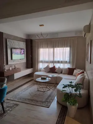 a living room with a couch and a table at Luxury Apartment with swimming pool in Gueliz Marrakech in Marrakech