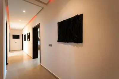 a hallway with a painting hanging on a wall at Villa Argana moderne et luxueuse piscine chauffée in Marrakech