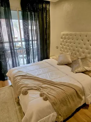 a large bed in a bedroom with a large window at Riad Garden Luxury Aparts by SABOR VOYAGE in Marrakech