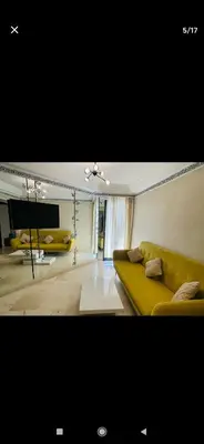 a living room with a yellow couch and a tv at Marrakesh in Marrakech