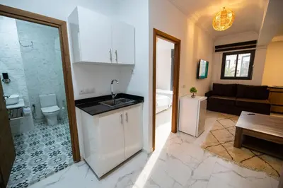 a kitchen with a sink and a toilet in a room at Jawhar Appart A3 in Marrakech