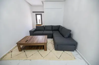 a living room with a couch and a coffee table at Jawhar Appart A4 in Marrakech