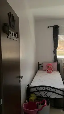a small bedroom with a bed and a window at Portes de Marrakech in Marrakech