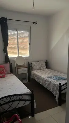 a bedroom with two beds and a window at Portes de Marrakech in Marrakech