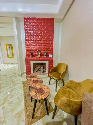 a living room with two chairs and a fireplace at Hamza Immobiler in Marrakech