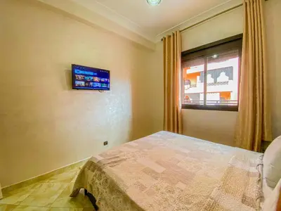 a bedroom with a bed and a window at Hamza Immobiler in Marrakech