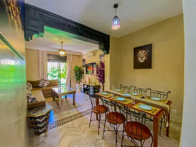 a living room with a table and chairs and a couch at Hamza immobiler in Marrakech