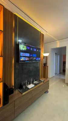a living room with a television on a wall at Marrakech menara in Marrakech