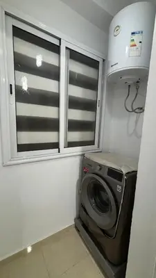 a laundry room with a washing machine and a window at Marrakech menara in Marrakech