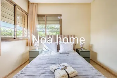 a bedroom with a bed with a nova home sign on it at Marrakech prestigia rez-de-jardin avec accès direct piscine golf in Marrakech