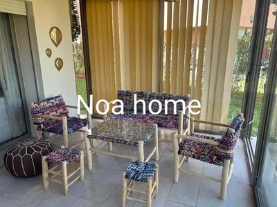 a porch with chairs and a sign that says nova home at Marrakech prestigia rez-de-jardin avec accès direct piscine golf in Marrakech