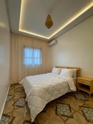 a bedroom with a large bed and a window at Appartement Neuf et Moderne in Marrakech
