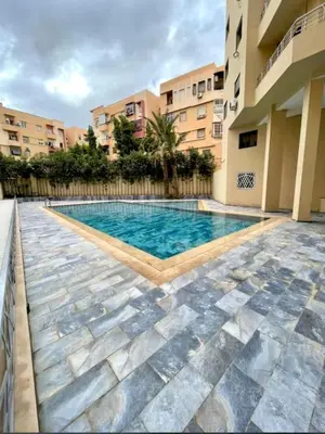 a swimming pool in the middle of a building at Stylish Apartment IN Marrakech E25 in Marrakech