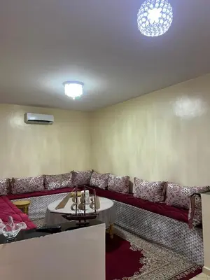 a living room with a red couch and a table at Appartement in Marrakech