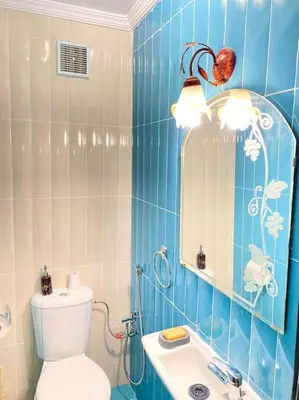 a blue tiled bathroom with a toilet and a sink at Apartment Comfortable Marrakech in Marrakech