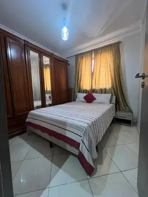 a bedroom with a large bed in front of a window at Appartement moderne a guéliz in Marrakech