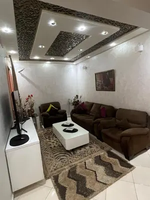 a living room with a couch and a table at Appartement moderne a guéliz in Marrakech