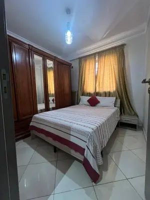 a bedroom with a large bed with a window at Appartement moderne a guéliz in Marrakech