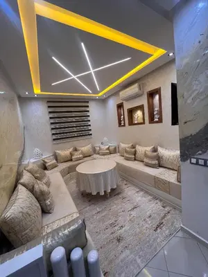 a living room with a couch and a table at Appartement Rénové avec Style et Parking surveillé in Marrakech