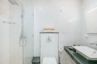 a bathroom with a shower and a toilet and a sink at Migdal Gueliz Apart Hôtel in Marrakech