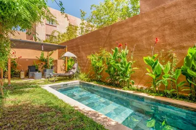 a swimming pool in the yard of a house at Modern Hivernage Duplex with Private pool in Marrakech