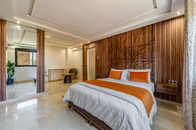 a bedroom with a large bed with orange pillows at Modern Hivernage Duplex with Private pool in Marrakech