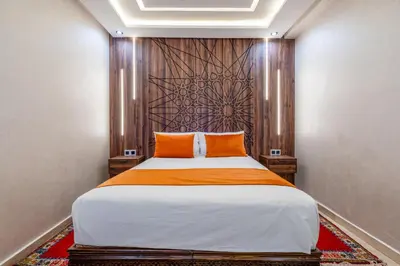 a bedroom with a large bed with orange pillows at Modern Hivernage Duplex with Private pool in Marrakech