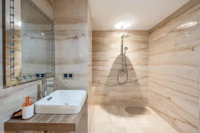 a bathroom with a sink and a shower at Modern Hivernage Duplex with Private pool in Marrakech