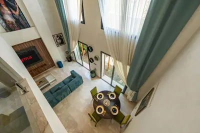 an overhead view of a living room with a couch and a table at Modern Hivernage Duplex with Private pool in Marrakech