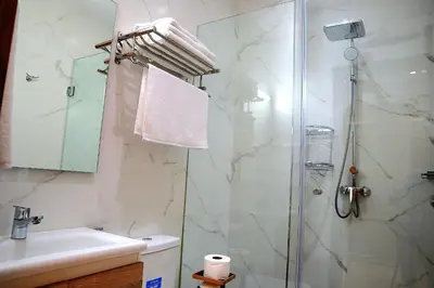 a bathroom with a shower and a toilet and a sink at The Elite suites in Marrakech