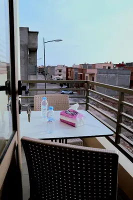 a table with a cake and water bottles on a balcony at The Elite suites in Marrakech