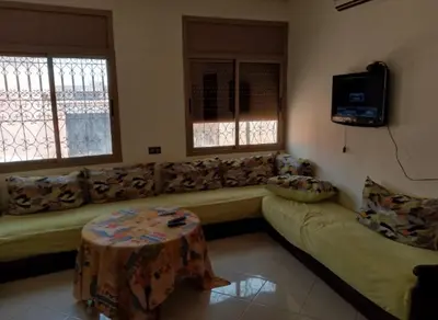 a living room with a couch and a table at Maison D'hôte Dar ALBIDAWI in Marrakech
