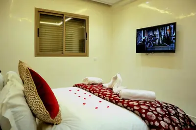 a bedroom with a bed with red pillows on it at Majestic luxe appartment in Marrakech