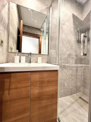 a bathroom with a sink and a mirror at Appartement De Luxe à Marrakech avec jacuzzi piscine et vue panoramique in Marrakech