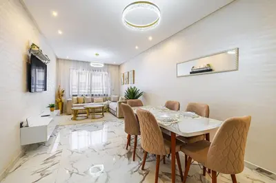 a dining room with a table and chairs at Family appartment Palmeraie Gate with pool in Marrakech