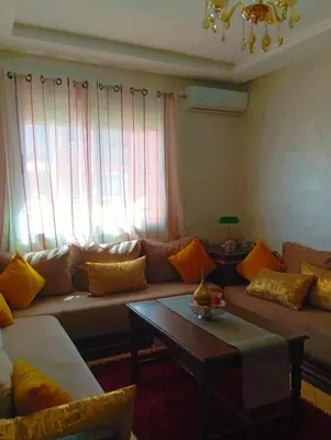 a living room with a couch and a coffee table at Appartement calme et spacieux in Marrakech