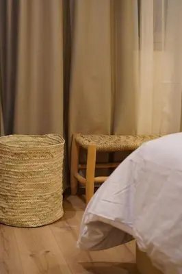 a bedroom with a bed and a chair and a table at Beldi Chic apartment in Marrakech in Marrakech