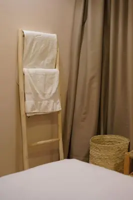 a towel hanging on a ladder next to a shower curtain at Beldi Chic apartment in Marrakech in Marrakech