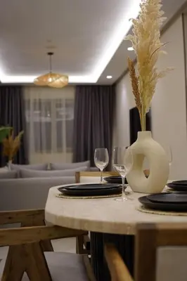 a table with two glasses and a vase on it at Beldi Chic apartment in Marrakech in Marrakech