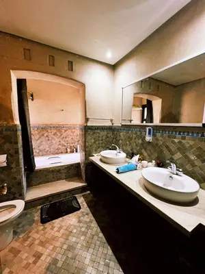a bathroom with two sinks and a large mirror at Casa Lina in Marrakech
